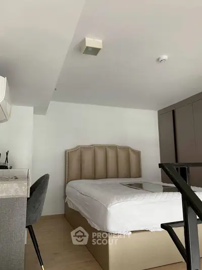 Modern bedroom with stylish bed and sleek furniture in a contemporary apartment.