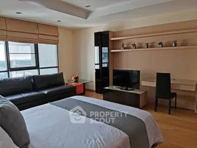 Modern bedroom with sleek design, featuring a cozy bed, stylish sofa, and a functional workspace.