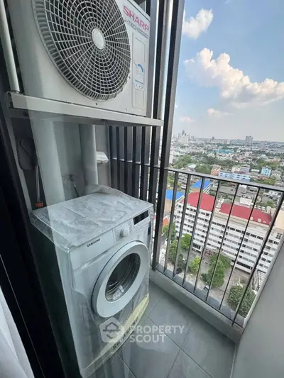 High-rise balcony with washing machine and city view, perfect for urban living convenience.