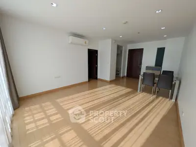 Spacious living room with dining area and natural light in modern apartment