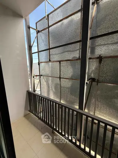Small balcony under construction with metal scaffolding and tiled floor