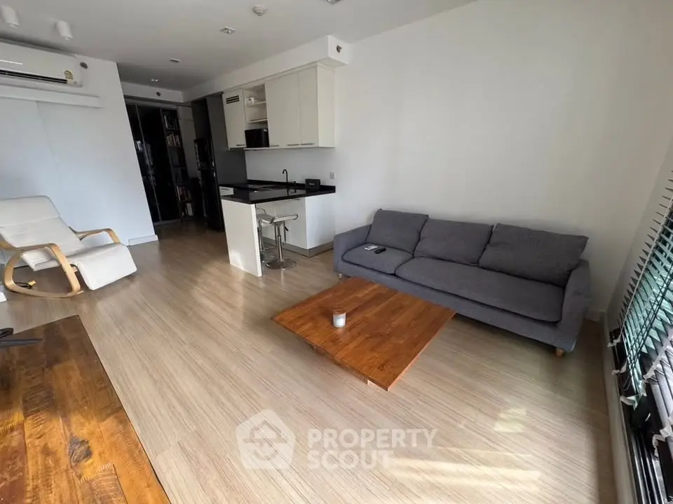 Modern living room with open kitchen and stylish furniture