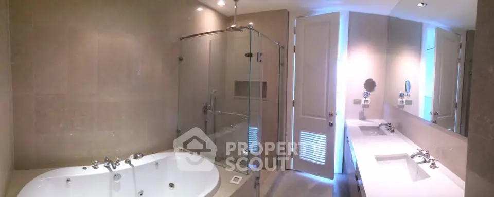 Luxurious modern bathroom with spacious bathtub and sleek glass shower enclosure.