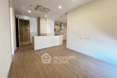 Spacious open-plan living area with modern kitchen and wooden flooring