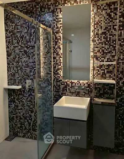 Modern bathroom with mosaic tiles and sleek fixtures