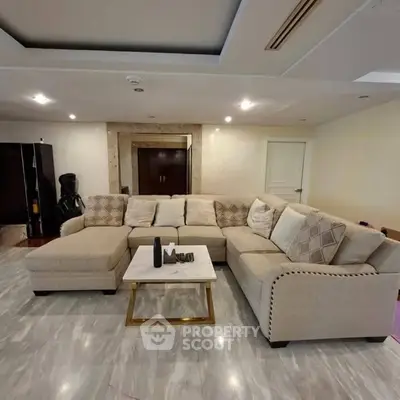 Spacious living room with elegant beige sectional sofa and modern decor