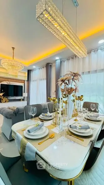 Luxurious dining area with elegant table setting and modern lighting in a stylish living room.