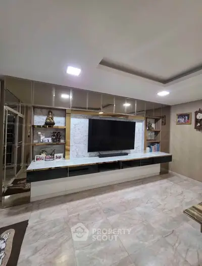 Luxurious living room with modern TV unit and marble flooring
