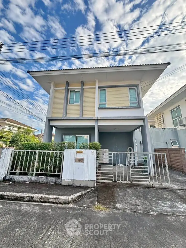 Charming two-story house with modern design and spacious front yard in a serene neighborhood.