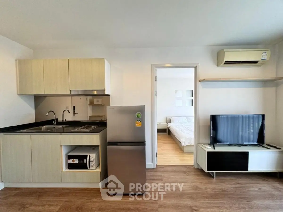 Modern studio apartment with compact kitchen and cozy living area