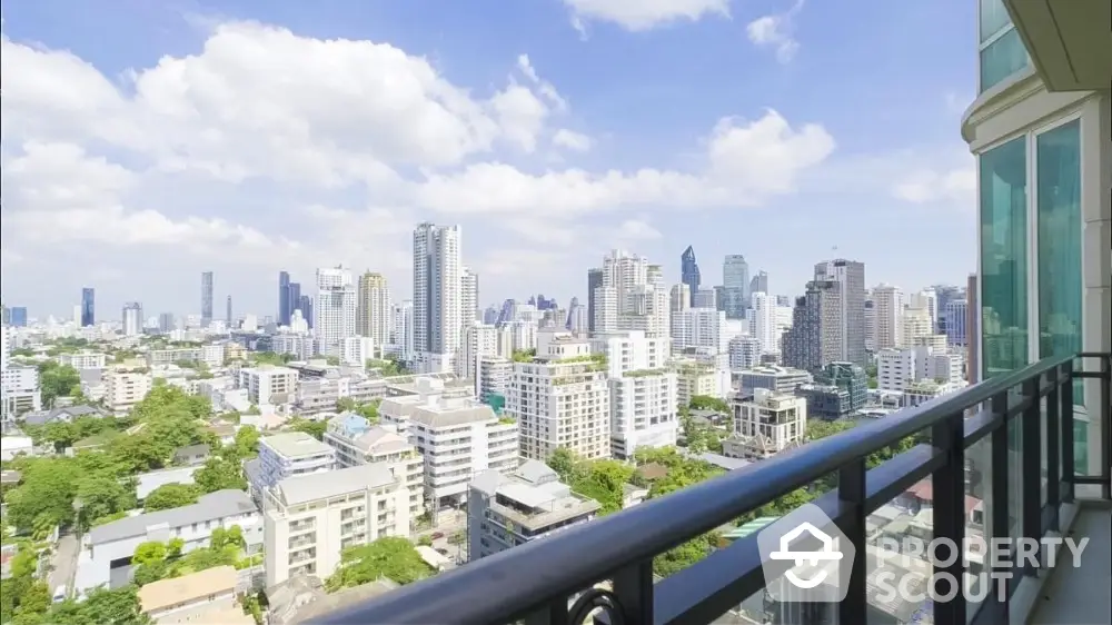 Stunning cityscape view from high-rise balcony with modern railing