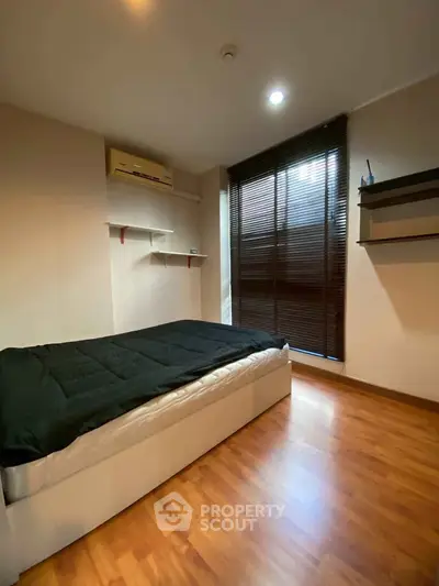 Cozy bedroom with wooden flooring and modern blinds
