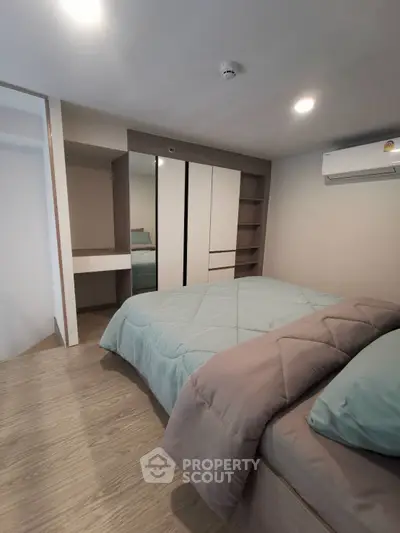 Modern bedroom with cozy bedding and sleek wardrobe design