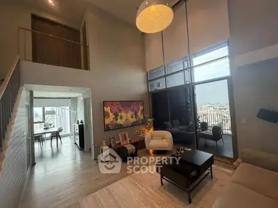 Spacious modern living room with high ceilings and city view balcony