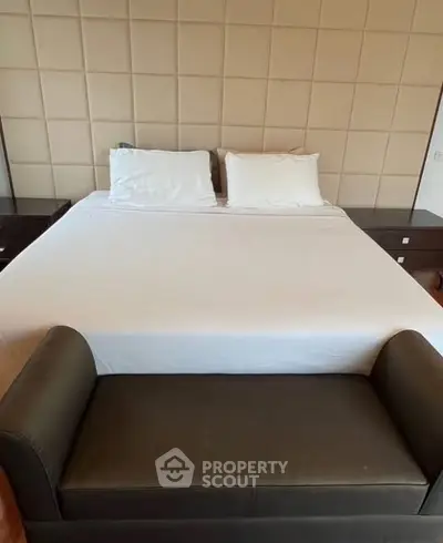 Luxurious bedroom with elegant decor and plush bedding in a modern real estate property.