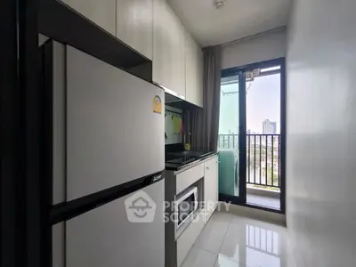 Modern kitchen with balcony view in urban apartment