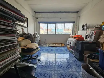 Spacious storage room with large window and organized boxes, ideal for home organization.