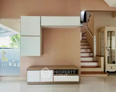 Modern interior with sleek storage unit and staircase in stylish home