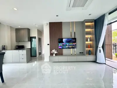 Modern living room with sleek design, open layout, and large windows offering natural light.