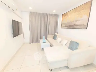 Modern living room with cozy white sofa and wall-mounted TV