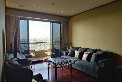 Spacious living room with city view and elegant furnishings in modern apartment.