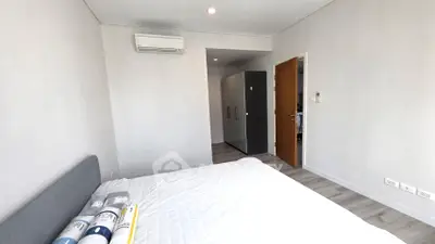 Modern bedroom with minimalist design and air conditioning in a contemporary apartment.