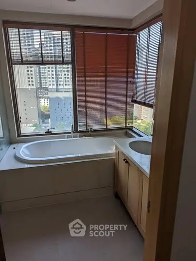 Luxurious bathroom with city view and elegant bathtub