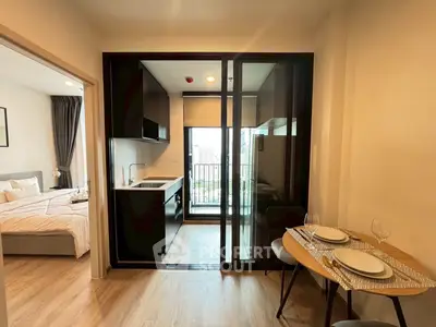 Modern apartment with cozy bedroom, sleek kitchen, and city view balcony.