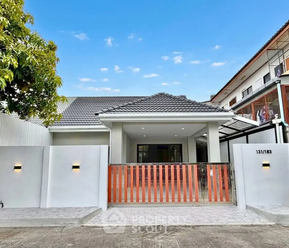 Charming single-story home with modern facade and gated entrance in a serene neighborhood.
