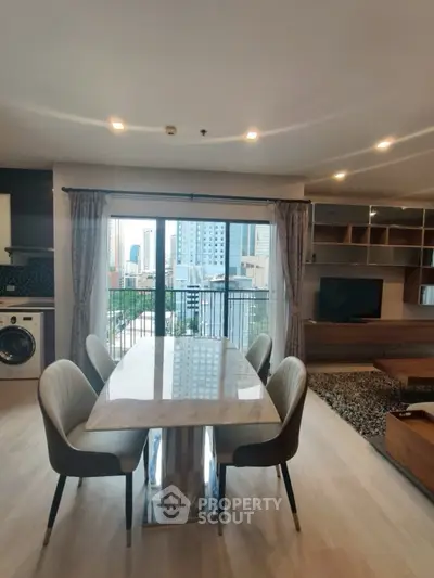 Modern living room with dining area and city view, featuring elegant furniture and natural light.