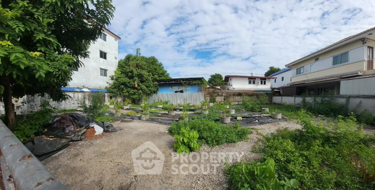 Vacant land plot surrounded by residential buildings, ideal for development opportunities.