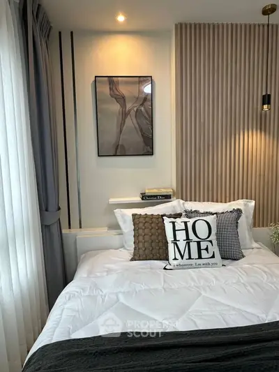 Cozy bedroom with modern decor and stylish accent wall, perfect for relaxation and comfort.