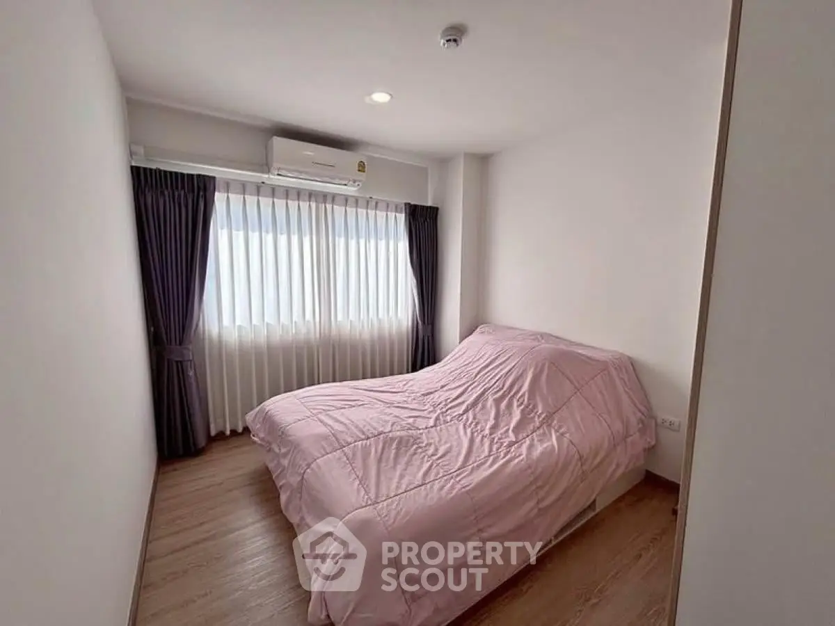 Cozy bedroom with natural light and modern decor, featuring a comfortable bed and elegant curtains.