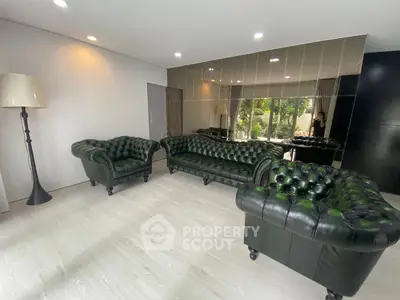 Luxurious living room with elegant green leather sofas and modern decor