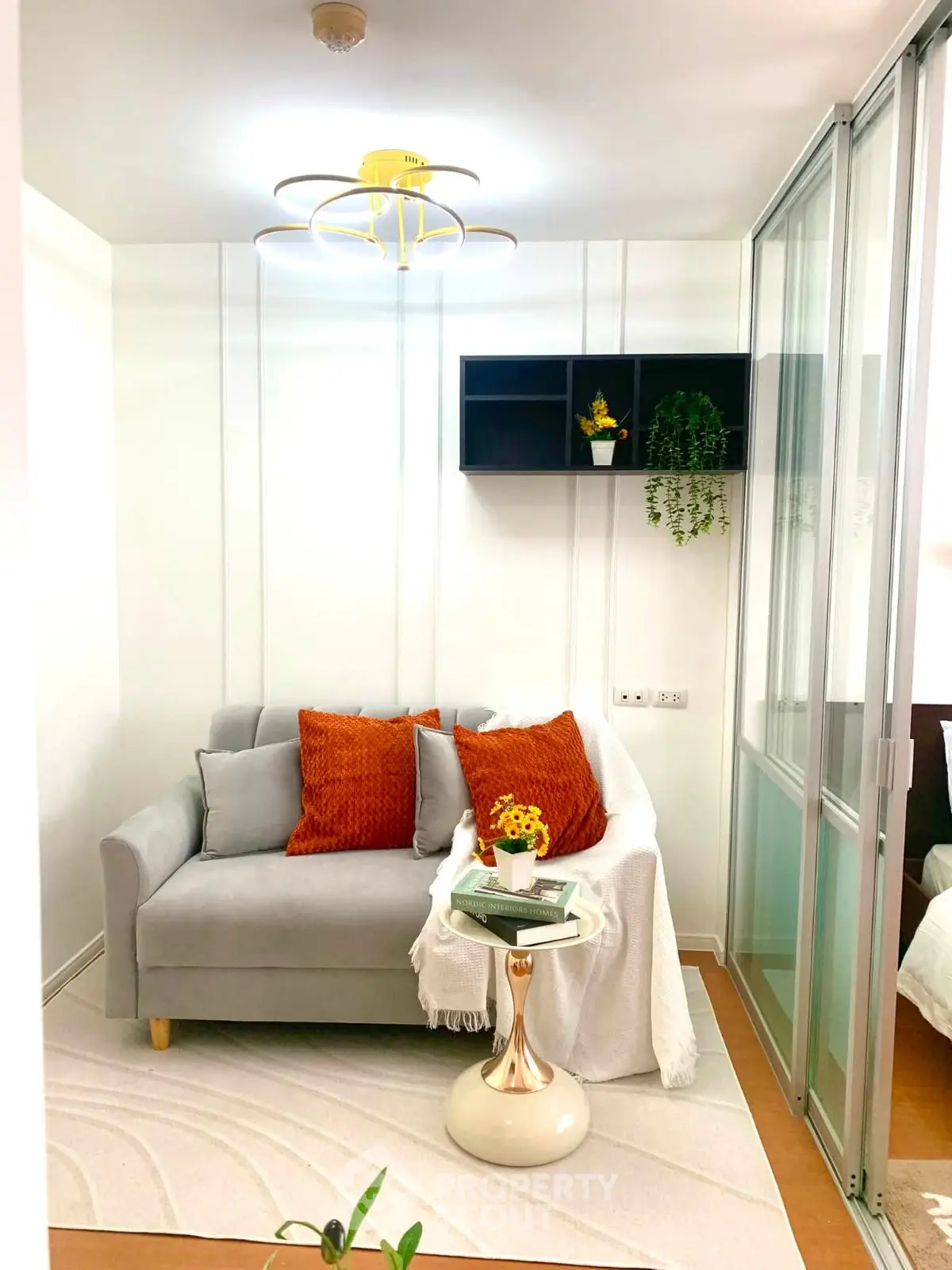 Chic modern living room with cozy sofa and stylish decor in a compact apartment.