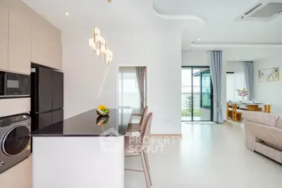 Modern open-plan kitchen and living area with sleek design and natural light