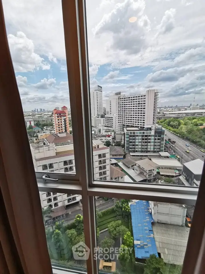 Stunning cityscape view from high-rise apartment window showcasing urban skyline.