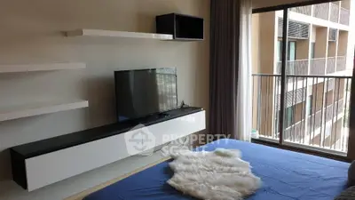 Modern bedroom with balcony view and sleek TV setup