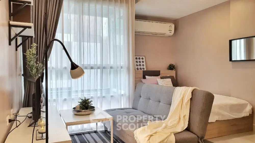 Modern studio apartment with cozy living area and natural light