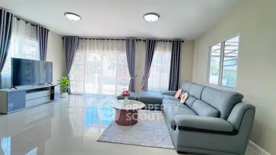 Spacious modern living room with sleek furniture and large windows for natural light.