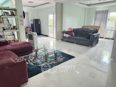 Spacious living room with modern furniture and large windows for natural light.