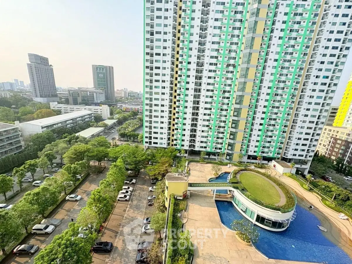 High-rise residential building with pool and city view, showcasing modern urban living.