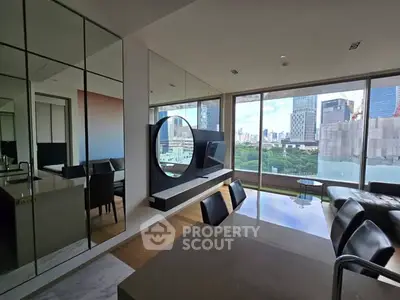 Modern living room with city view, sleek furniture, and large windows.