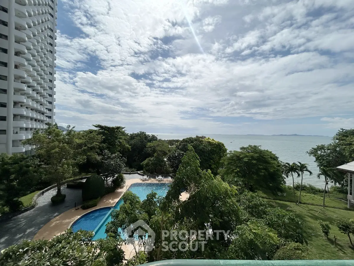Stunning ocean view from a high-rise building with lush greenery and a sparkling pool.