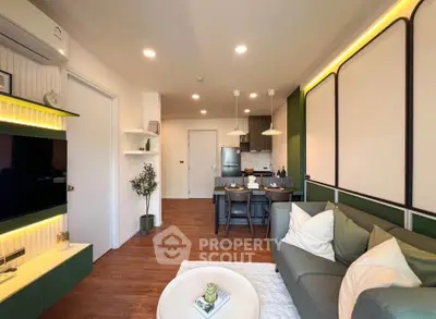 Modern living room with open kitchen, stylish decor, and cozy seating area in a contemporary apartment.