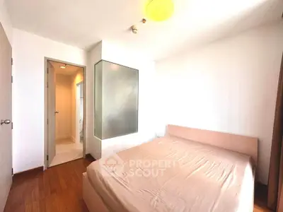 Bright and cozy bedroom with ensuite bathroom and wooden flooring
