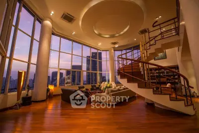 Luxurious penthouse living room with stunning city view and elegant spiral staircase.