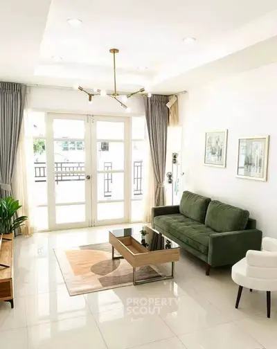 Bright and modern living room with green sofa and elegant decor