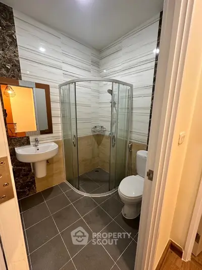 Modern bathroom with glass shower and sleek tile design
