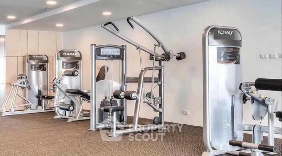 Modern gym with state-of-the-art fitness equipment in luxury residential building.